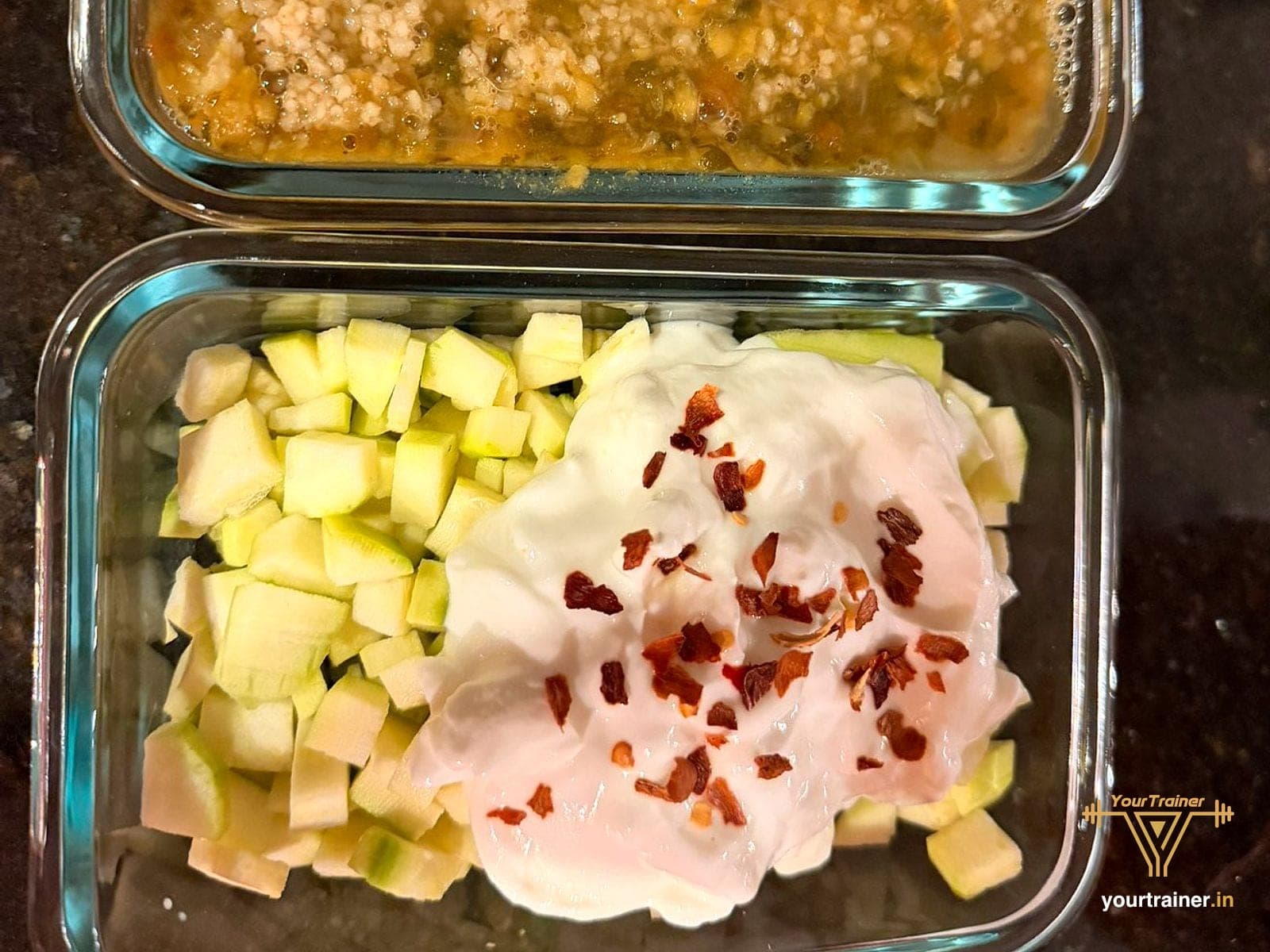 Packed lunch in glass boxes: khichdi, and cucumber with curd