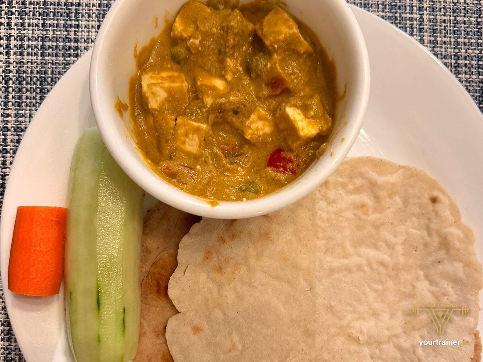 Phulkas with a paneer curry, carrot and cucumber