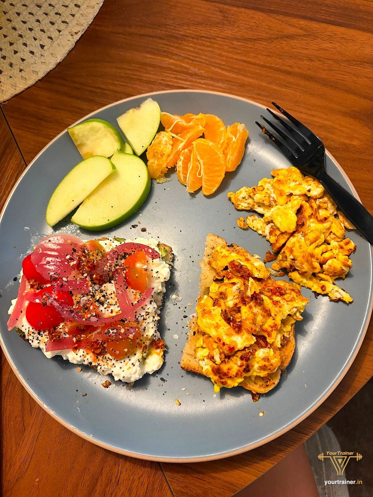 Member breakfast plate with cottage cheese toast, scrambled eggs on toast, apple slices and orange segments