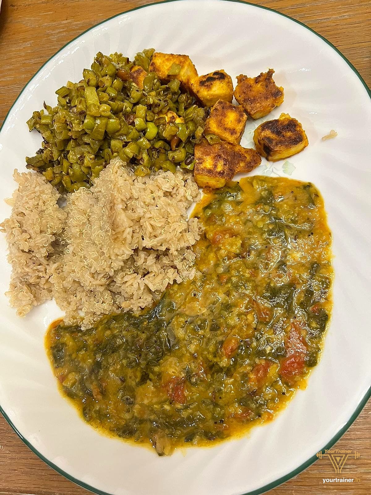 Plate with millet rice, dal, palak, beans and paneer