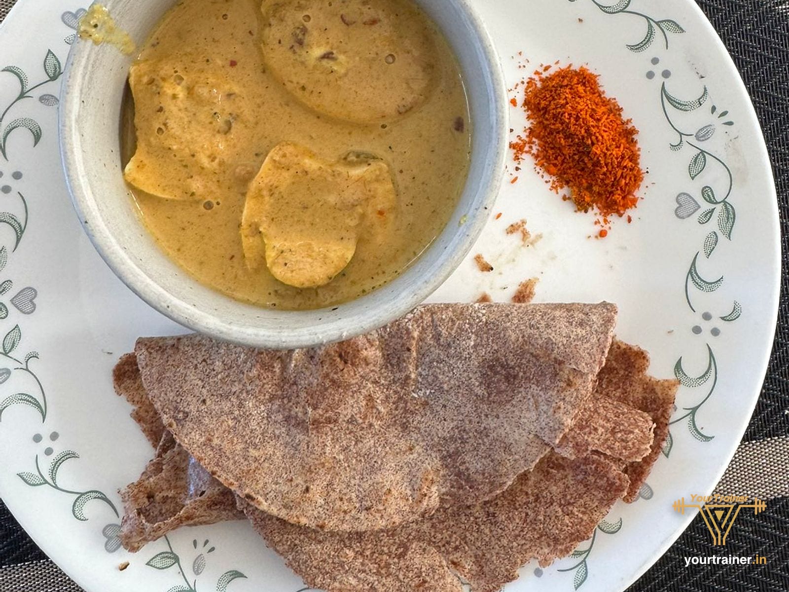 Ragi roti with a bowl of curry and chutney powder